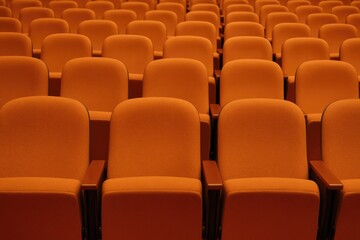 Fototapeta premium Vacant orange-colored seats in the theater auditorium