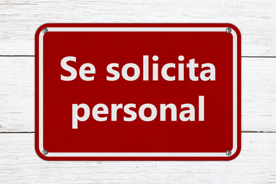 Help Wanted Se solicita personal red sign on weathered wood