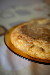 Traditional Spanish Potato Omelette on a Rustic Plate with Warm Light