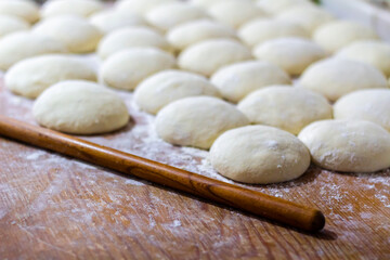 Homemade dough on wooden table at home.
