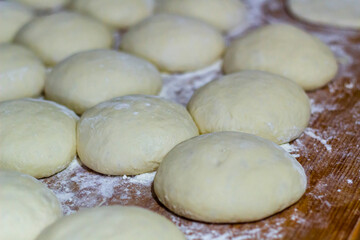 Homemade dough on wooden table at home.