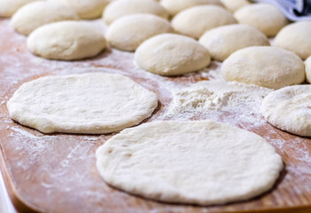 Homemade dough on wooden table at home.