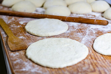 Homemade dough on wooden table at home.