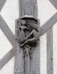 Carved relief sculpture on a building in Blois, France depicting intricate human figures