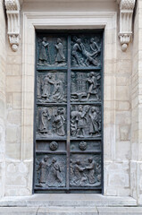 Exploring the detailed bronze doors of Eglise Saint-Pierre de Montmartre in Paris