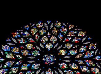 Stained glass rose window of Sainte-Chapelle, vibrant colors and intricate designs, interior
