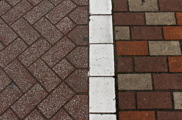 Texture of square paving tile. Two different patterns of brown, orange, and beige sidewalk tiles...