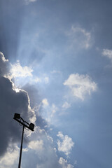 Silhouette of Floodlights Against Dramatic Cloudy Sky