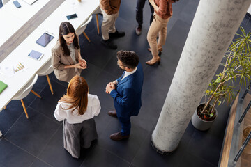 Top view of businesspeople chatting at office on a break.
