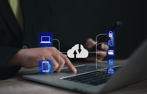 Entrepreneur syncing data between laptop and smartphone through cloud system, with secure icons for image, folder, file, and email, representing seamless digital integration and backup.