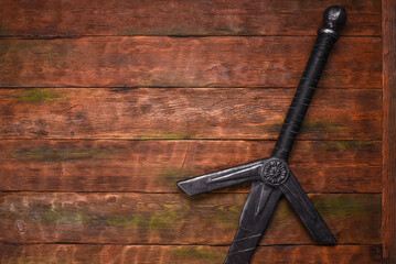 Old long medieval two handed knight warrior sword on ancient table flat lay background with copy...