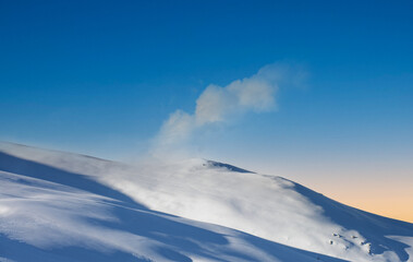 ends the day with a beautiful sunset in the high mountains among the snowy winter