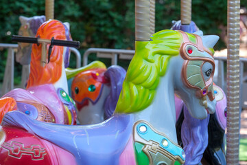 Colorful carousel horses waiting for joyful riders at the park