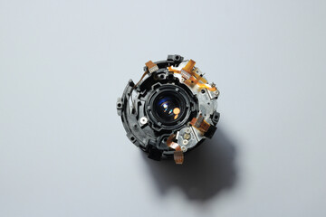 The black inner casing of a camera lens being disassembled, there is optical glass, flexible track,...
