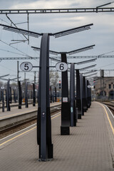 Modern railway platform at Baltic train station (Estonian - Balti Jaam) in Tallinn, Estonia. Symmetrical lines, track numbers and urban infrastructure - minimalistic travel and transportation scene
