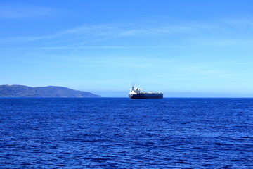 container ships on Strait of Gibraltar with morocco mountains in background