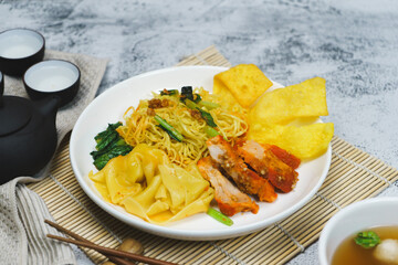 Egg noodle soup with red roasted pork and pork wontons Chinese food