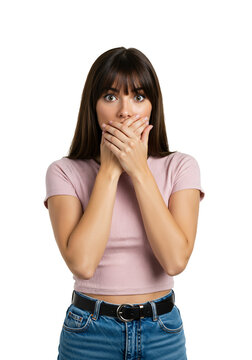 Shocked young woman covering her mouth with hands in disbelief. Surprised brunette girl with bangs looking at camera on isolated transparent background.