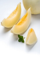 Fresh honeydew melon cut in half with detailed texture and a single wedge beside it, isolated on white, hyperrealistic, commercial style