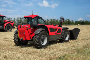 Fototapeta premium Agricultural excavator or loader with bucket for field cleaning.