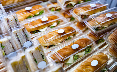 Pre-packaged sandwiches displayed in a commercial refrigerator