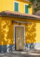 Bright Yellow Building with Green Shutters