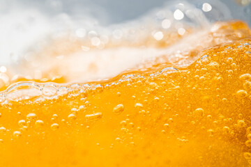Close up bright orange Oil or beer splash texture and nature waves, Beautiful waves curve and...