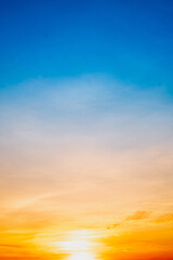 Sky,Beautiful sunset view, luxury soft gradient orange gold clouds and sunlight on the blue dramatic sky perfect for the background, morning, evening,Twilight, climate change,Vertical sunset photo