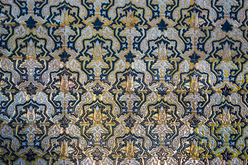 Close-up of lustrous Mudéjar-style azulejos in Seville. Interlacing floral and geometric motifs...