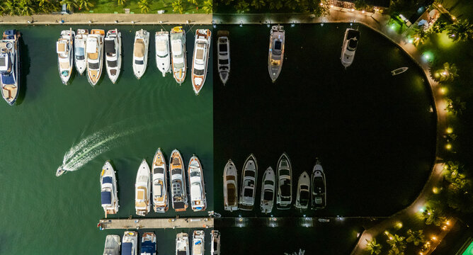 Top-down drone photo of a palm-lined marina in Angra dos Reis, Rio de Janeiro state. Luxury yachts sit moored along the curved seawall while a small craft leaves a white wake across deep green water. 