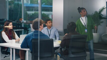 Confident CEO leads diverse startup tech team in night office meeting, brainstorming strategy, coding ideas, business growth, and software development with programmers and professionals collaborating - Powered by Adobe