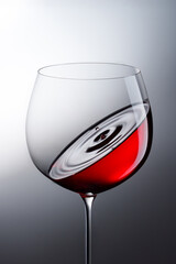 Red wine swirl in glass with ripple effect