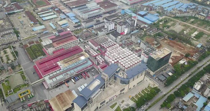 Explore the vibrant aerial view of a bustling brewery in HD showcasing its vast facilities and surroundings