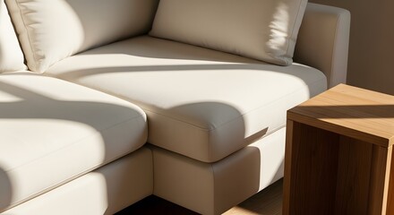 Soft beige sectional sofa with wooden side table and cushion