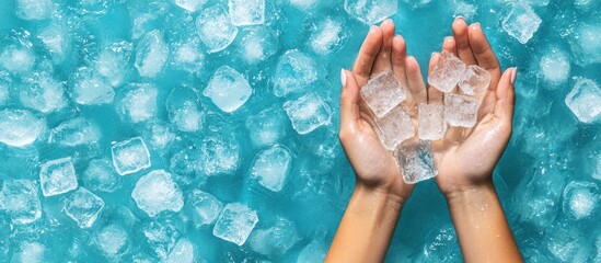 Fototapeta premium Hands holding ice cubes above an ocean of crystal clear ice water background
