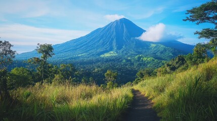 Fototapeta premium Panoramic vista of majestic mountain peaks and luxuriant vegetation under a clear sky
