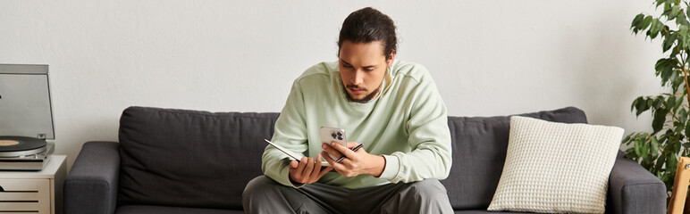Young man enjoys a relaxing afternoon while reading at home in a cozy living space