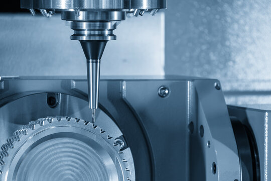 The 5-axis CNC milling machine cutting the gear part with solid ball nose end mill tools in the light blue scene.
