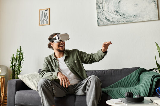 Young handsome man enjoying virtual reality experience in cozy home setting with excitement