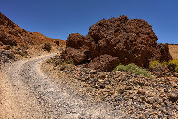Curved trail through volcanic terrain