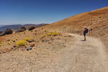 Woman hiking among lava boulders