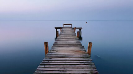 Obraz premium Wooden pier stretching into calm ocean, a serene escape into simplicity and peace