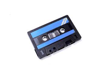 Black vintage audio cassette tape isolated on white background. Retro style background. Top view, flat lay, copyspace