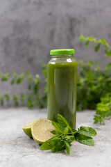 Healthy green vegetable detox smoothies in a glass bottle,Vegetable cocktail, Raw, vegan, vegetarian, detox, alkaline food concept