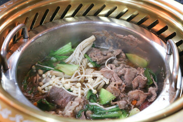Sukiyaki ,suki or shabu pot and sliced beef or vegetable soup in the pot