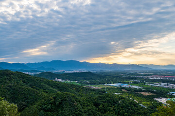 The urban green fields beneath the sea of clouds at Beijing's Baiwang Mountain, China.

