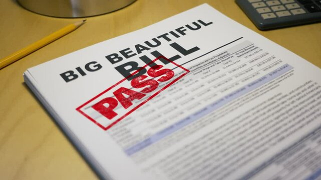 Close-up of a political document titled &ldquo;BIG BEAUTIFUL BILL&rdquo; stamped with a bold red &ldquo;PASS.&rdquo; Scene includes a pencil, calculator, and desk&mdash;symbolizing legislation approval or policy reform. 14705	