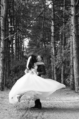 young couple a guy and a girl are walking in the green hills