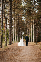 young couple a guy and a girl are walking in the green hills