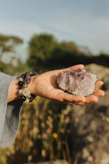 Close-up of female hands holding natural healing stones. Tools for energy balance, emotional...